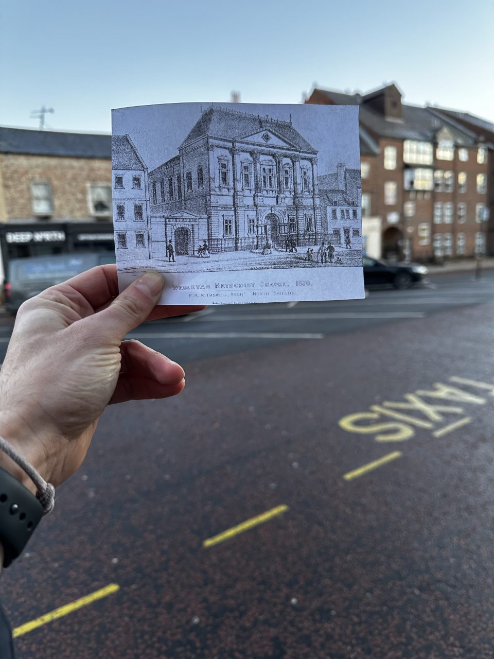 Old photo of Front Street Methodist Chapel held up to current site