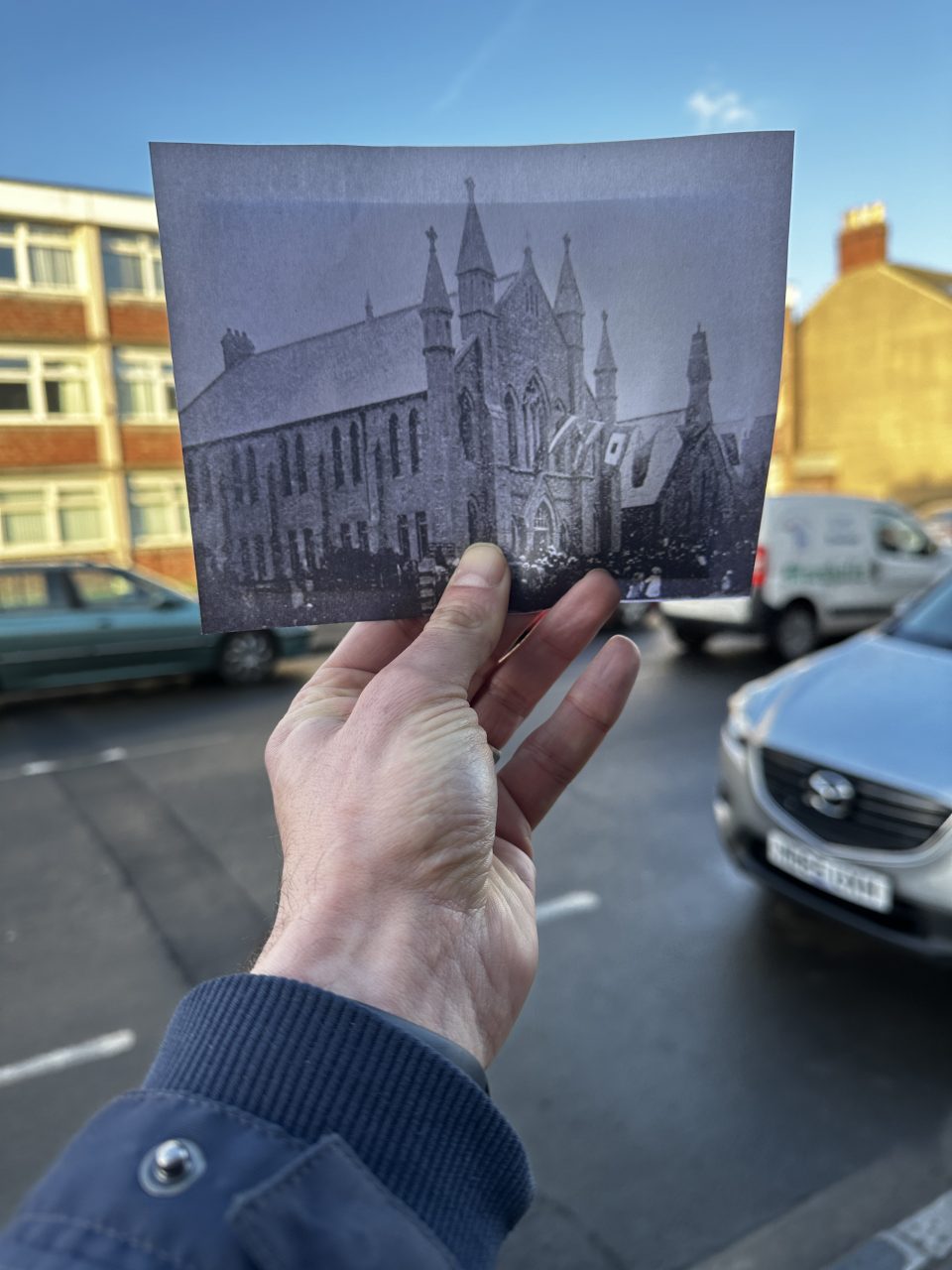 Old photo of John Street Methodist Chapel held up to current site